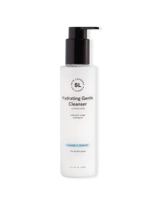 A clear bottle of Skin Laundry Hydrating Gentle Cleanser with a black pump dispenser. The label states "w/ amino acids" and indicates it's designed to "CLEANSE + HYDRATE" for "all skin types."